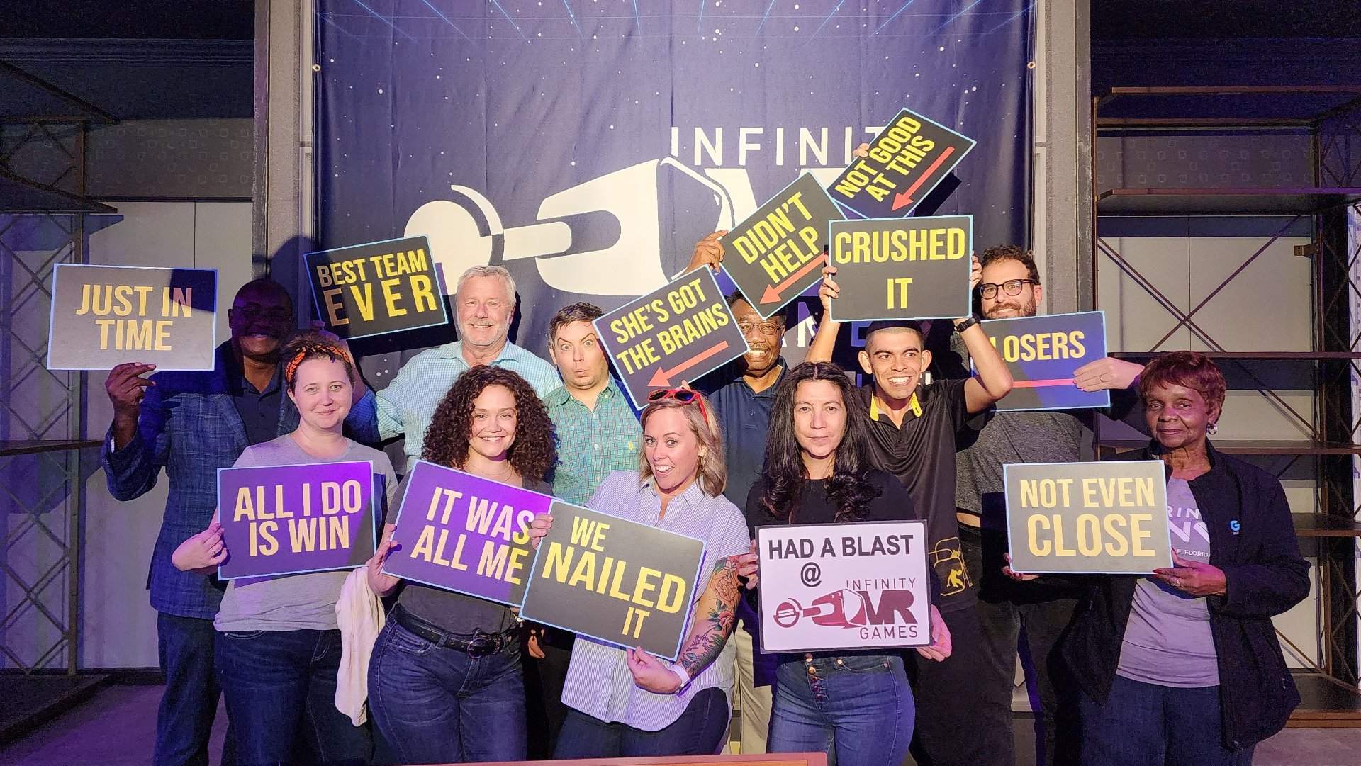 A big team posing after completing a game at Infinity VR
